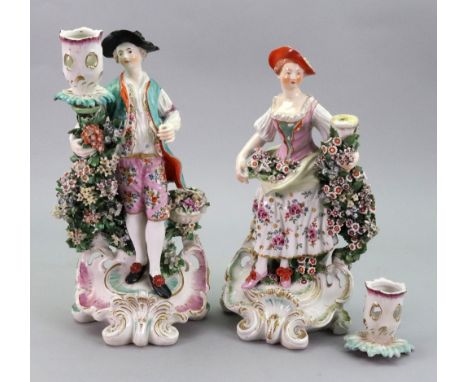 Two Derby porcelain candlestick figures, circa 1770, modelled as a young man and companion, he with a basket of fruit and flo