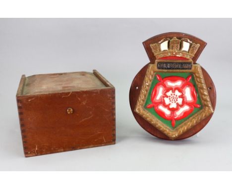 A mahogany cased Williams &amp; Co. Falmouth compass, with sliding cover, the box 20cm square and a Cumberland plaque (2). 