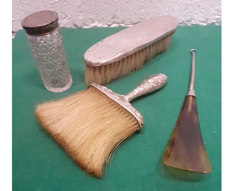 A Sterling silver handled brush and another, a silver topped glass dressing table pot and a button hook with tortoiseshell st