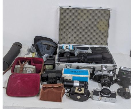 A collection of cameras and camera equipment to include a Minolta X-300 and XGI, SRT101b and others together with telephoto l