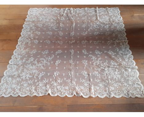 An Edwardian cream embroidered lace tablecloth A/F on button mesh ground with scalloped edges having embroidered images of fl