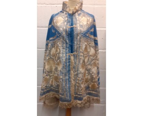 A mid 19th Century Anglo-Indian embroidered cape having blue ground with intricate cream silk embroidered images of shells, a