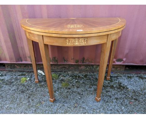 A mid 20th century Italian Sorrento inlaid fold over card table, inset green baize, on square tapering legs and block feet, 7