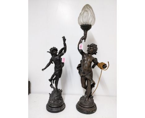 After Moreau - a French 19th century patinated spelter figural table lamp of a young boy scantily draped holding aloft a flam