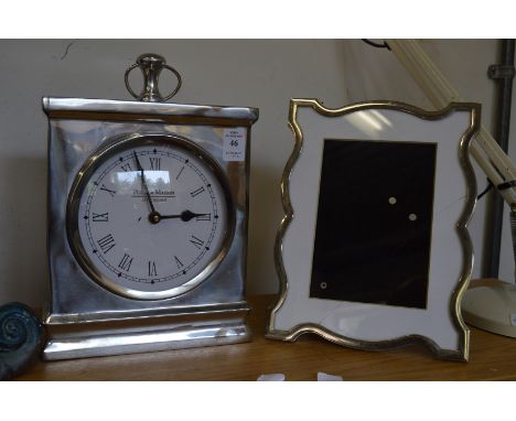 A Jeff Banks mantel clock and a picture frame.
