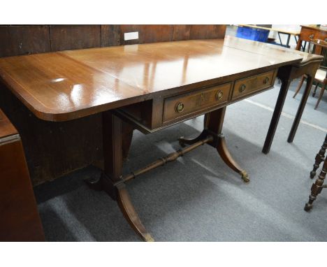 A reproduction mahogany sofa table.