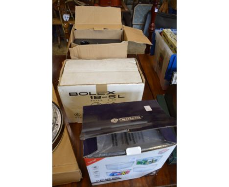 Storage containers, a Bolex film projector and a surround sound system.