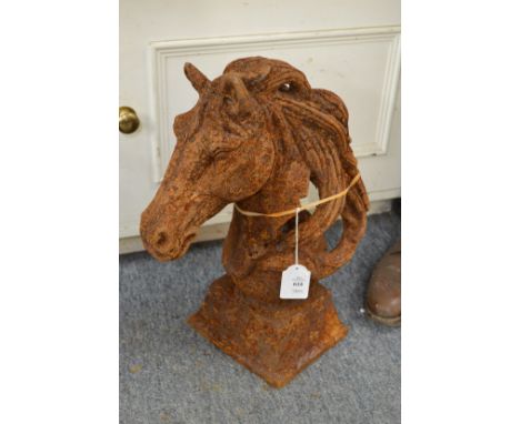 A pair of cast iron horse head gate post finials.