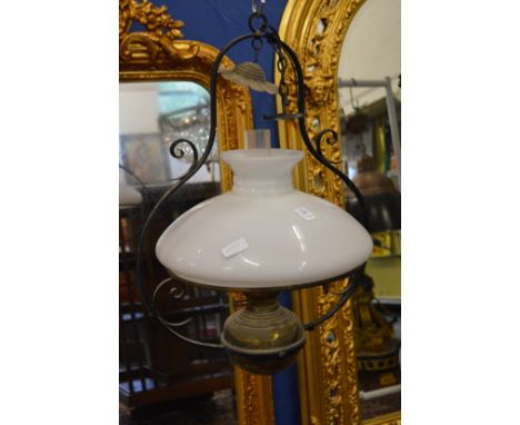 A Spanish style brass and wrought iron and glass hanging lantern.