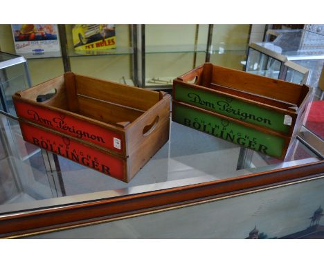 A pair of wooden storage boxes decorated with champagne names.