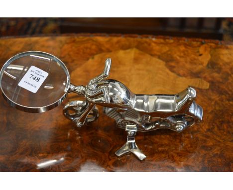 A magnifying glass the handle modelled as a motorbike.