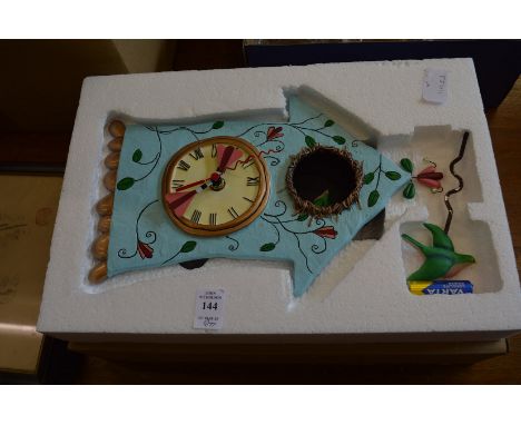 A decorative wall clock, three Oriental pictures and two decorative mirrors.