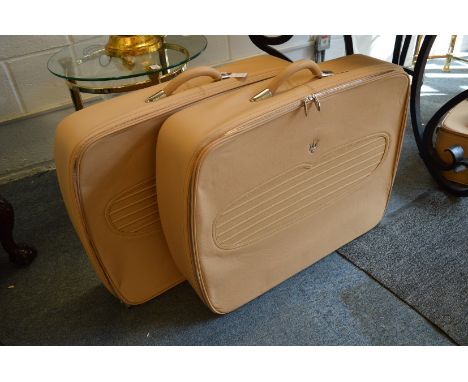 A suite of Maserati tan leather luggage.