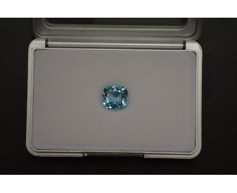 A cushion shaped blue topaz, boxed with certificate.