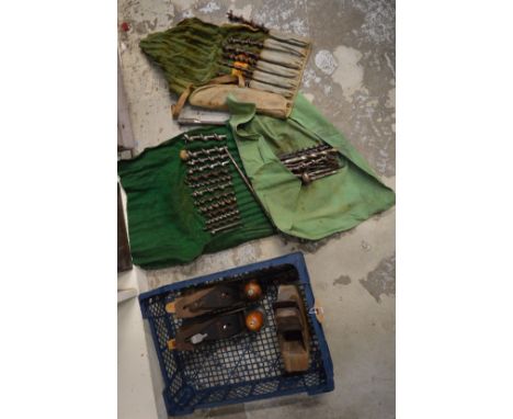 Old wood working planes and drill bits.