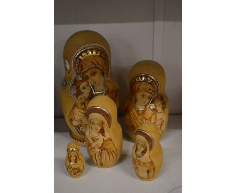A set of five Russian wooden dolls with poker work and gilded decoration.