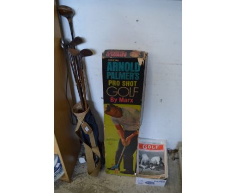 Old golf clubs, an Arnold Palmers Pro-shot golf game and other items.