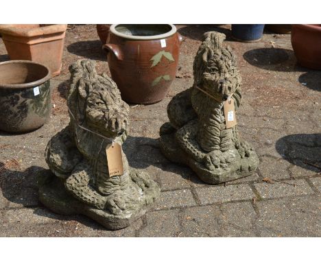 A pair of reconstituted stone garden ornaments modelled as dragons.