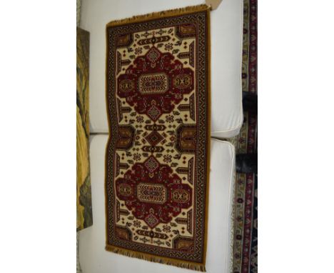 A small Persian style rug, 93cm x 42cm.
