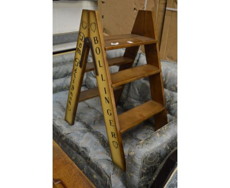 A pair of novelty step ladders with champagne names down the side.