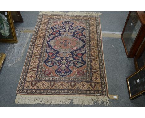 A small Persian style rug, 140cm x 95cm.