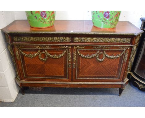 A French style ormolu mounted mahogany two drawer, two door commode.