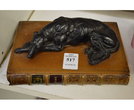 Paperweight modelled as a bronze greyhound on a leather book.