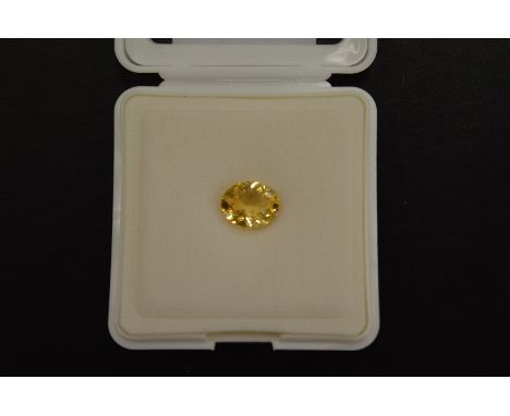 An oval cut citrine, boxed with certificate.