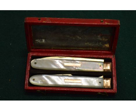 A good silver gilt and mother of pearl fruit knife and fork, in fitted leather case.