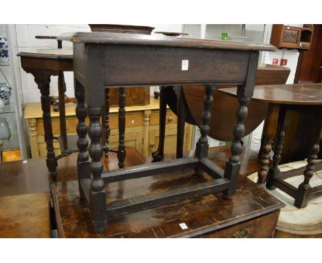 An oak occasional table on bobbin turned supports.