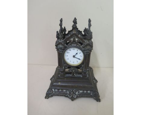 A bronze monument mantle clock, 21cm tall, movement appears overwound otherwise good condition 