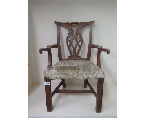 A carved oak chippendale style childs open armchair with upholstered seat 59cm tall, 45 cm wide, 29cm deep 