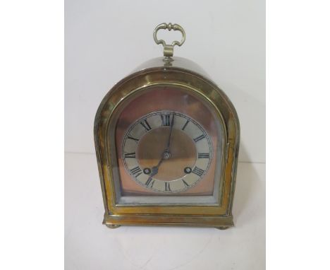 A good brass dome top striking mantle clock, 24cm tall,  ticks but stops, with key 