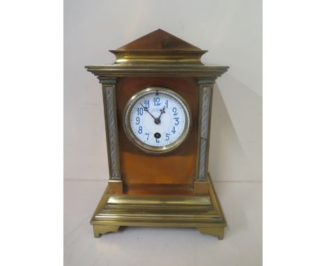 A J W Benson brass and copper mantle clock with an enamelled dial. 26cm tall, missing pendulum, faint cracks to dial, one por