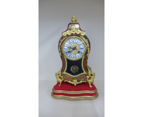 A French Boulle mantle clock with ormolu mounts on a gilt stand 36cm tall, striking on a bell, running has some restorations,