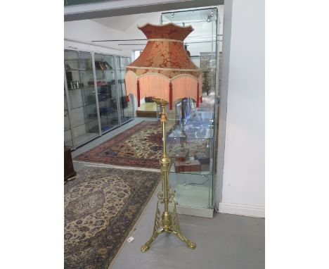 A brass orangery conservatory standard oil lamp now converted to electric with a fringed shade, 183cm tall, in good polished 