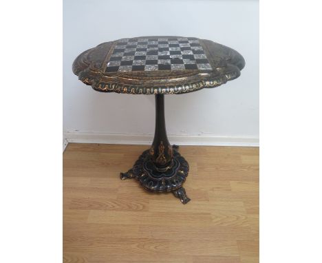 A Victorian papier mache and mother of pearl tilt top sidetable with a chess board top, stamped Jennens &amp; Bettridge in or