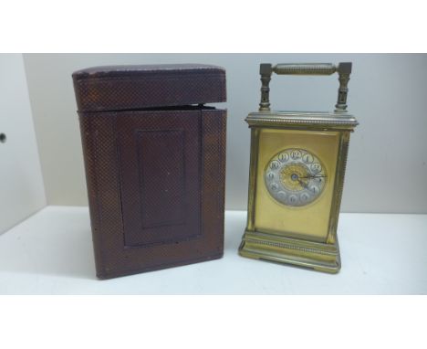A nice quality carriage clock 8 day movement strikes hours and half with travel case. In running order, small chip to back gl