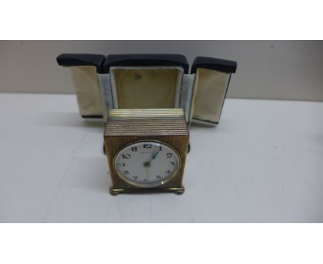 A Zenith travel alarm clock with outer case with a 4cm dial, running in saleroom. 