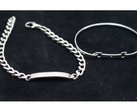 Silver ID bracelet together with a silver bangle 