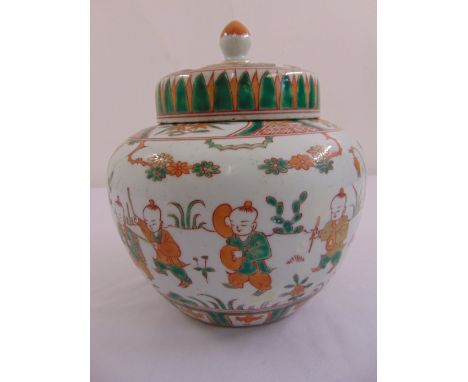 A Chinese famile verte ginger jar decorated with children playing, with raised pull off cover and bud finial