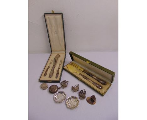 A quantity of continental white metal to include cased servers, a patch box, coasters and miniature figurines (10)