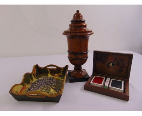 A turned wooden Acanto vase and cover, playing card box with hinged cover to include playing cards and a painted wooden tray