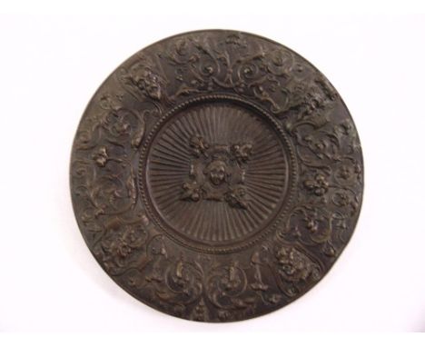 A bronze circular embossed plaque of the four winds in Renaissance style