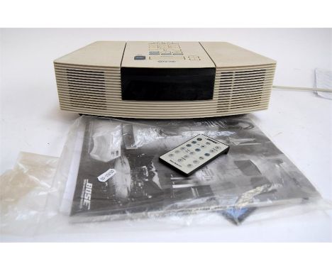 A Bose Wave radio/CD model AWC3G in white, with remote and instructions