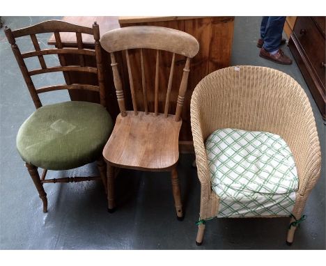 A Lloyd Loom armchair, together with a pine stick back armchair, and one other