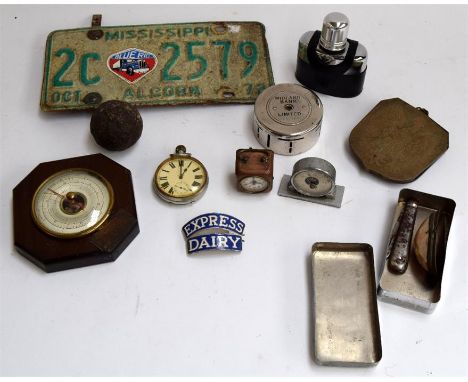A mixed lot to include an Express Dairy enamel badge, a Mississippi licence plate from 1972, a canon ball, pocket watch, and 