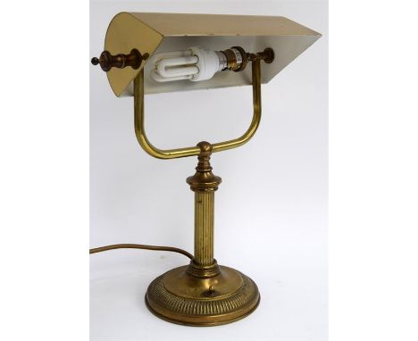 A brass banker's desk lamp with circular base