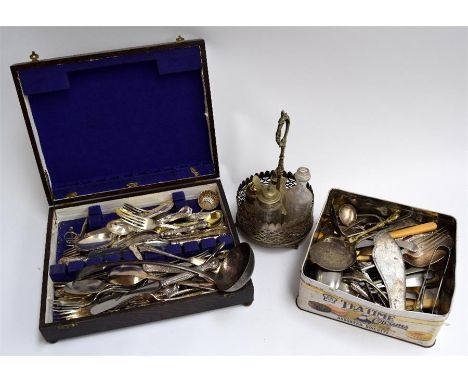 A mixed tin of flatware and a ladle, together with a canteen of cutlery