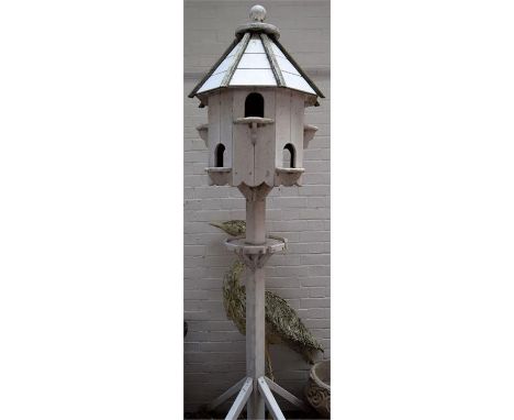 A white painted octagonal dovecote and a model heron